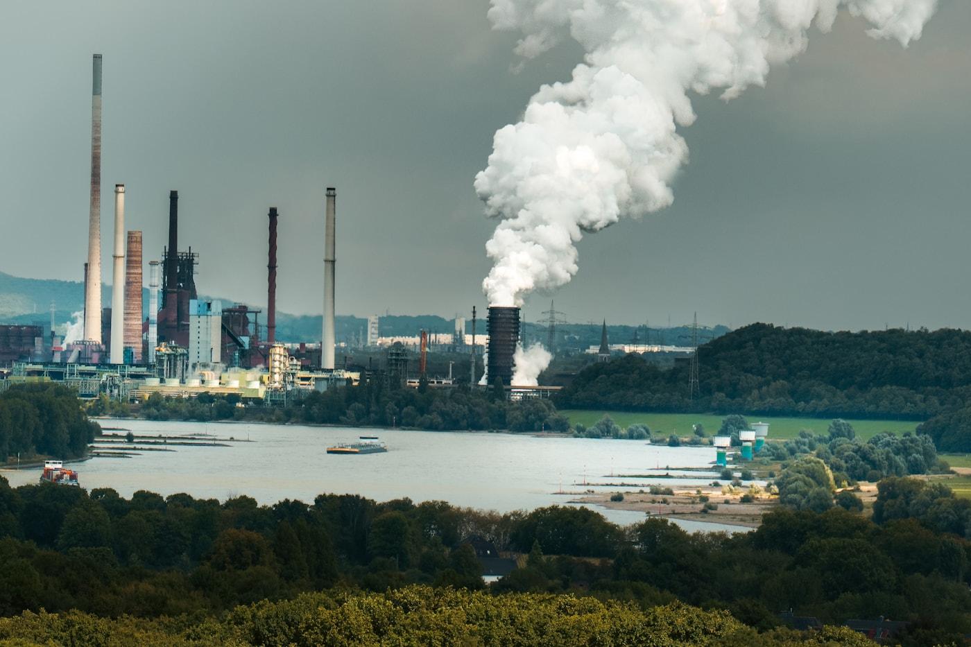 Industrial complex with thick smoke billowing from chimneys, Duisburg Germany