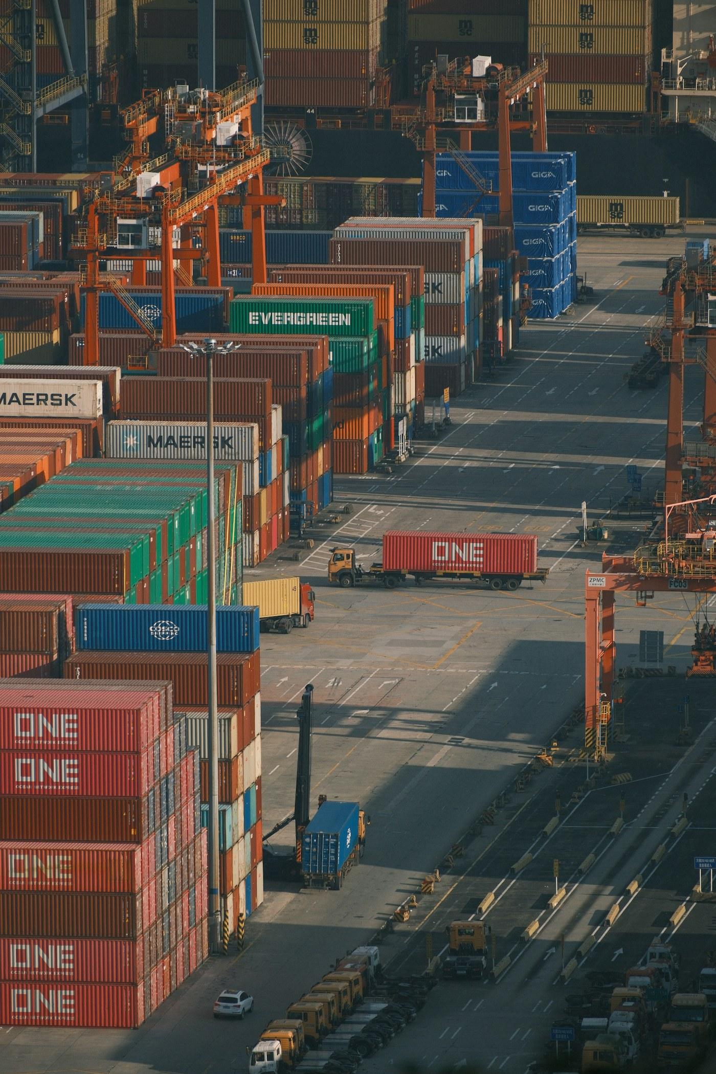 Shipping containers stacked high at a busy container port